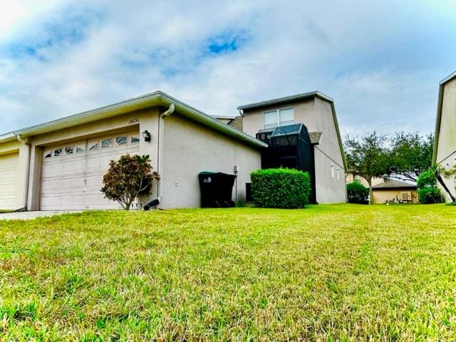 view of side of home featuring a lawn and a garage