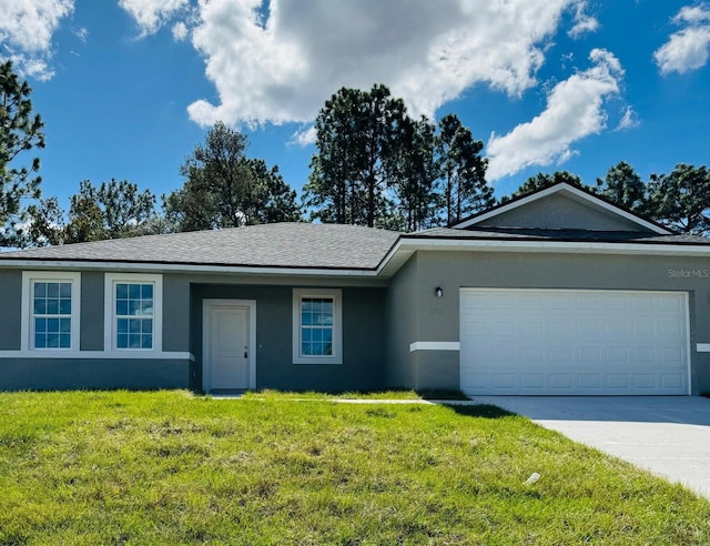 ranch-style home featuring a garage and a front lawn