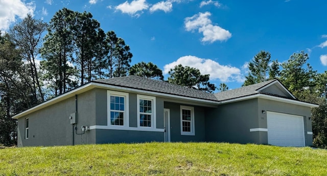 single story home with a front lawn and a garage