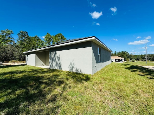 view of side of home featuring a lawn