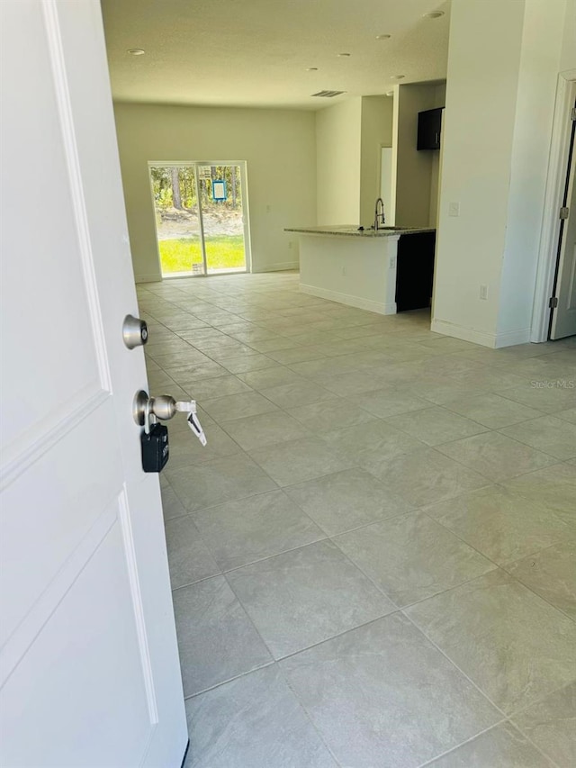 interior space featuring light tile patterned floors and sink