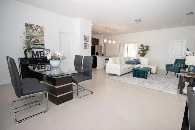 dining area with tile patterned flooring and a chandelier