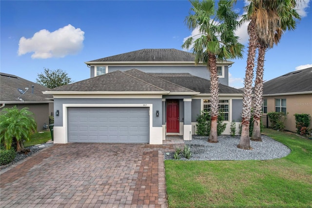 view of front of property with a garage and a front lawn