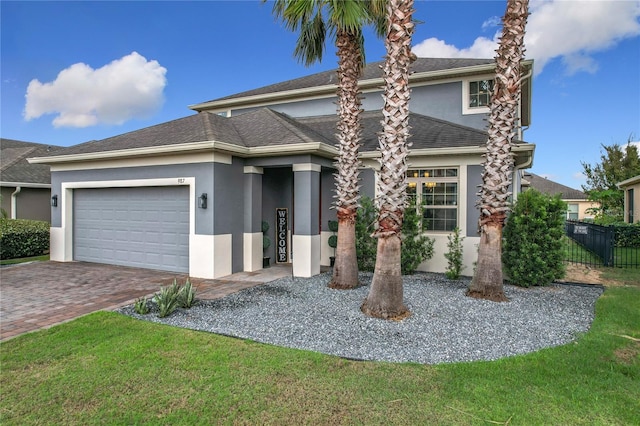 view of front of home with a garage and a front lawn