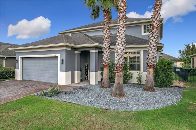 987 Nathan Ridge Rd, Clermont, FL 34715 - view of front facade featuring stucco siding, driveway, and an attached garage
