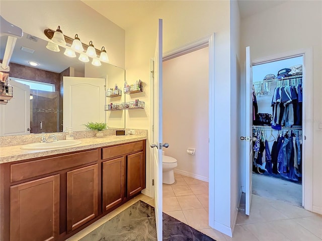 987 Nathan Ridge Rd, Clermont, FL 34715 - bathroom with tile patterned floors, a stall shower, a walk in closet, vanity, and toilet