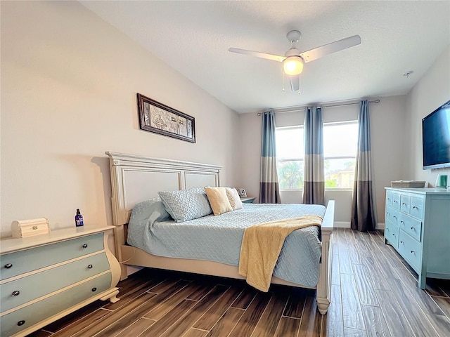 bedroom featuring a textured ceiling, dark wood-type flooring, and ceiling fan