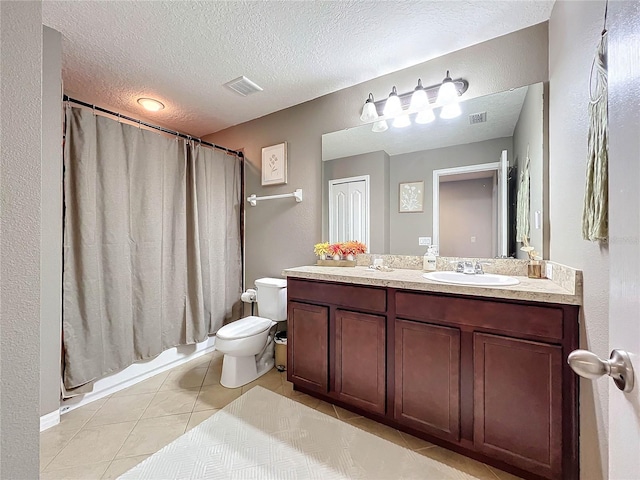 full bathroom featuring toilet, tile patterned flooring, a textured ceiling, vanity, and shower / tub combo with curtain