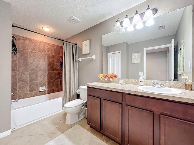 full bathroom with vanity, a textured ceiling, tile patterned flooring, toilet, and shower / bath combo with shower curtain