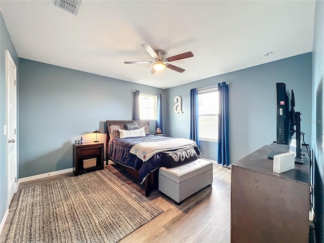 bedroom featuring a textured ceiling, hardwood / wood-style flooring, and ceiling fan