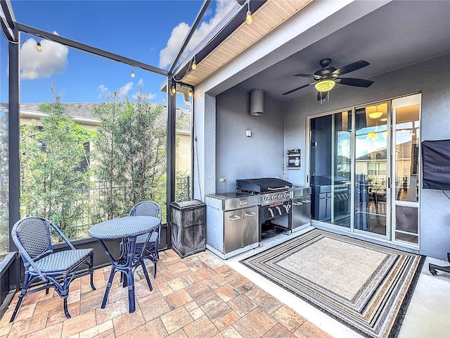 sunroom featuring ceiling fan