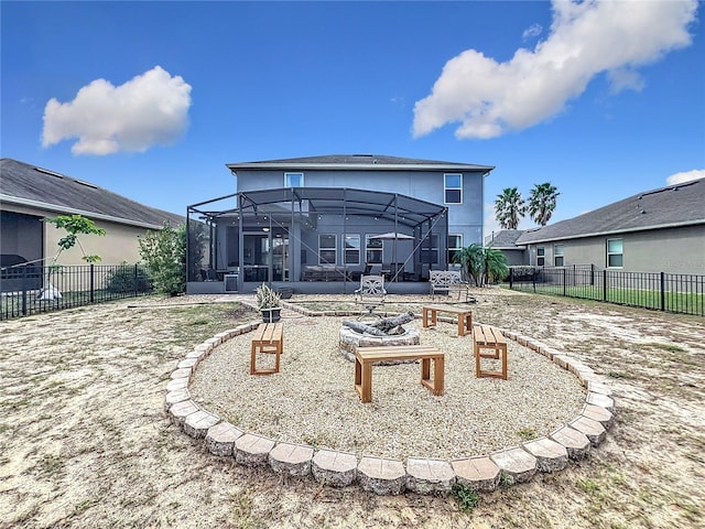 back of house featuring a lanai, a fire pit, and a sunroom