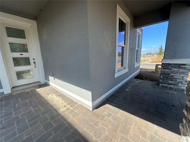 entrance to property featuring stucco siding