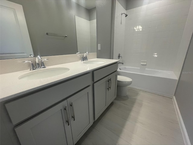 full bath with double vanity, toilet,  shower combination, and a sink