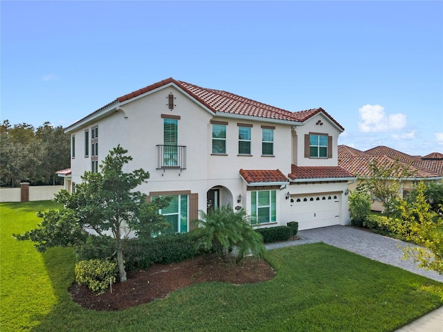 mediterranean / spanish-style house with a garage and a front yard