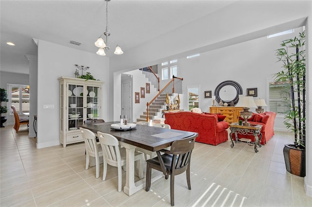 dining room featuring a chandelier and light tile patterned floors