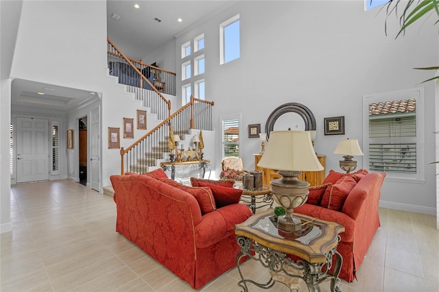 tiled living room with a high ceiling and a healthy amount of sunlight