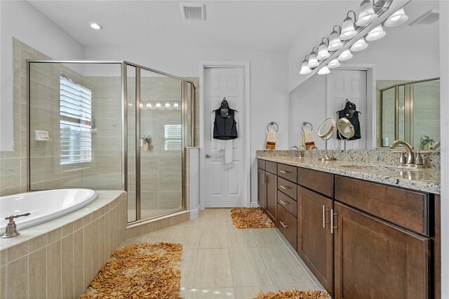 bathroom with independent shower and bath, vanity, and tile patterned floors