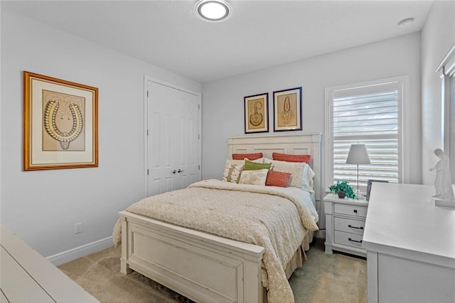 bedroom featuring a closet and light carpet