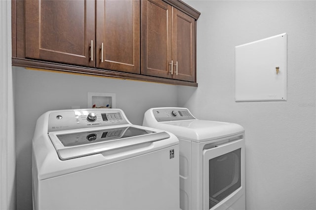 laundry area featuring cabinets and separate washer and dryer