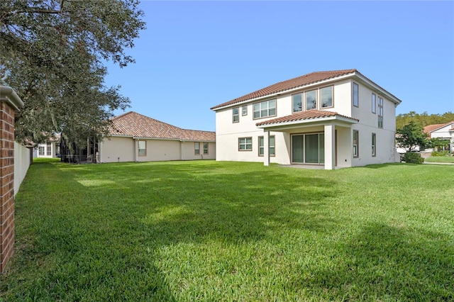 rear view of house with a yard