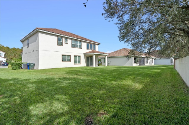 rear view of house with a lawn