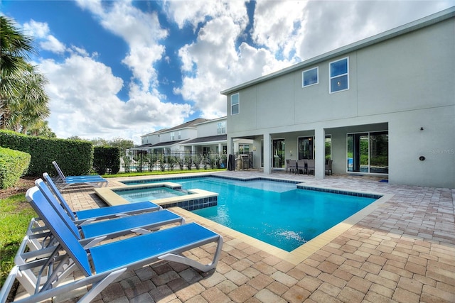 view of swimming pool with an in ground hot tub and a patio area