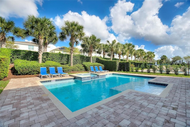 view of swimming pool with an in ground hot tub and a patio area