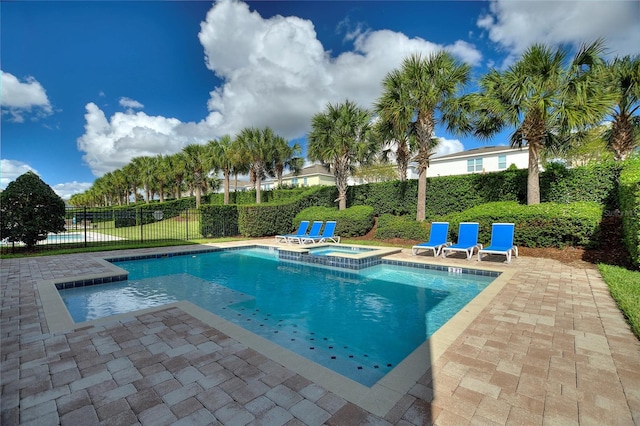 view of pool with a patio and an in ground hot tub