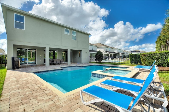 view of pool featuring an in ground hot tub and a patio area