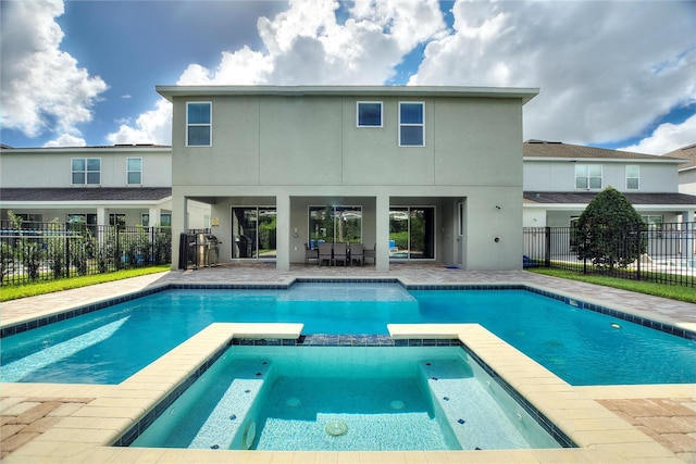 view of pool with an in ground hot tub and a patio area