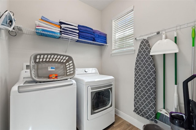 washroom featuring washing machine and dryer and wood-type flooring