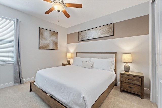 bedroom with ceiling fan and light carpet