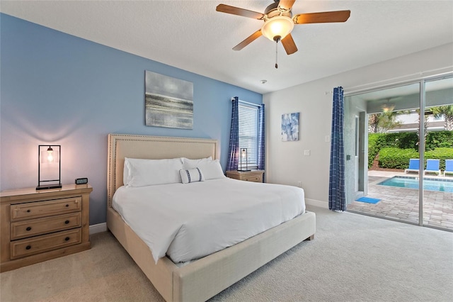 carpeted bedroom featuring a textured ceiling, ceiling fan, and access to exterior