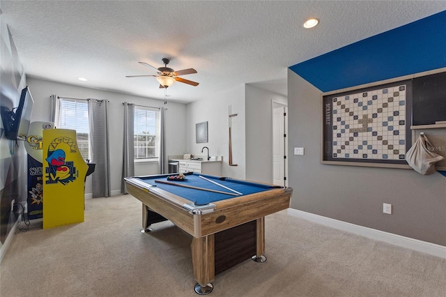 playroom with pool table, light colored carpet, a textured ceiling, sink, and ceiling fan