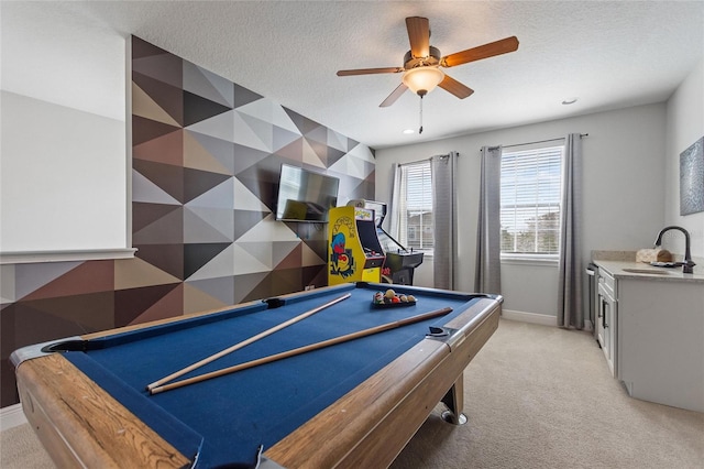 game room with sink, pool table, a textured ceiling, and light colored carpet