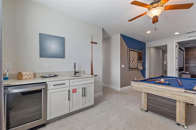 game room with light carpet, wine cooler, sink, ceiling fan, and billiards