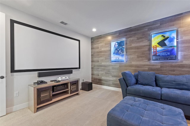 carpeted cinema room featuring wooden walls