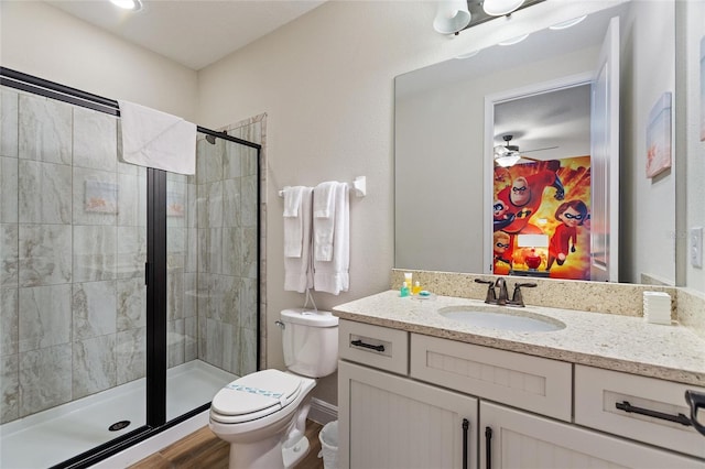 bathroom with toilet, an enclosed shower, vanity, and hardwood / wood-style flooring