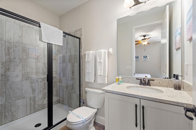 bathroom with walk in shower, ceiling fan, vanity, and toilet