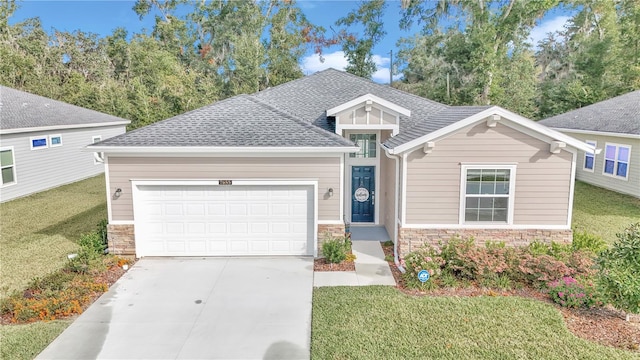 view of front of property with a garage and a front lawn