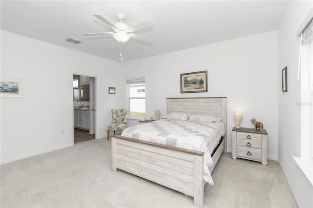 carpeted bedroom with connected bathroom and ceiling fan