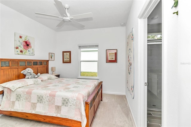 carpeted bedroom with ceiling fan and connected bathroom