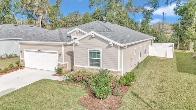 view of front of home with a garage and a front lawn