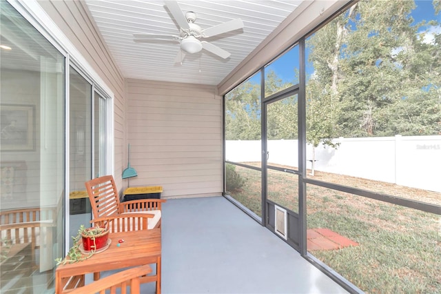 sunroom / solarium featuring ceiling fan