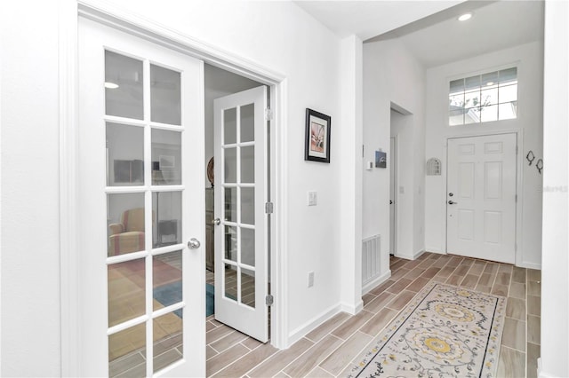 foyer entrance with wood-type flooring and french doors