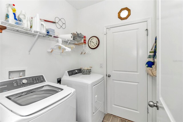 laundry area with independent washer and dryer and light hardwood / wood-style floors