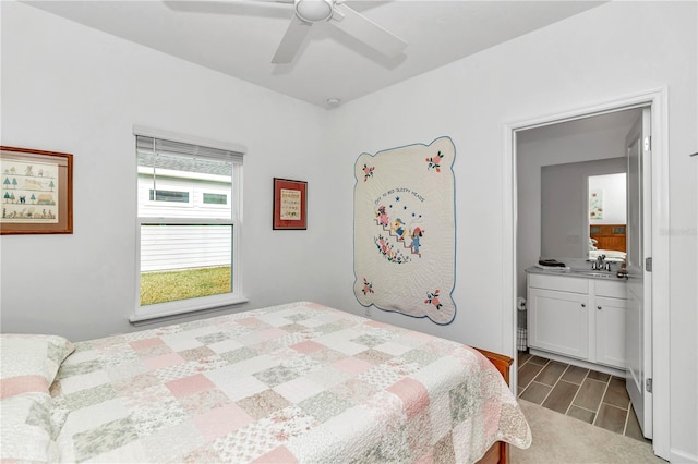 bedroom featuring hardwood / wood-style flooring, ceiling fan, sink, and connected bathroom