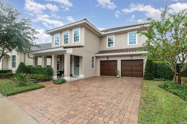 mediterranean / spanish-style house with a garage