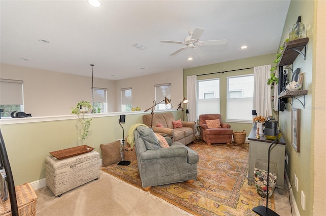 carpeted living room featuring ceiling fan